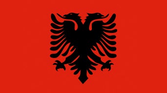 Albanian flag with a red background and a black double-headed eagle in the centre.