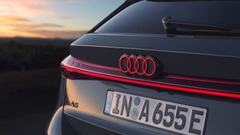 Close up on the read coloured rear lights and logo of an Audi A6 Avant e-tron