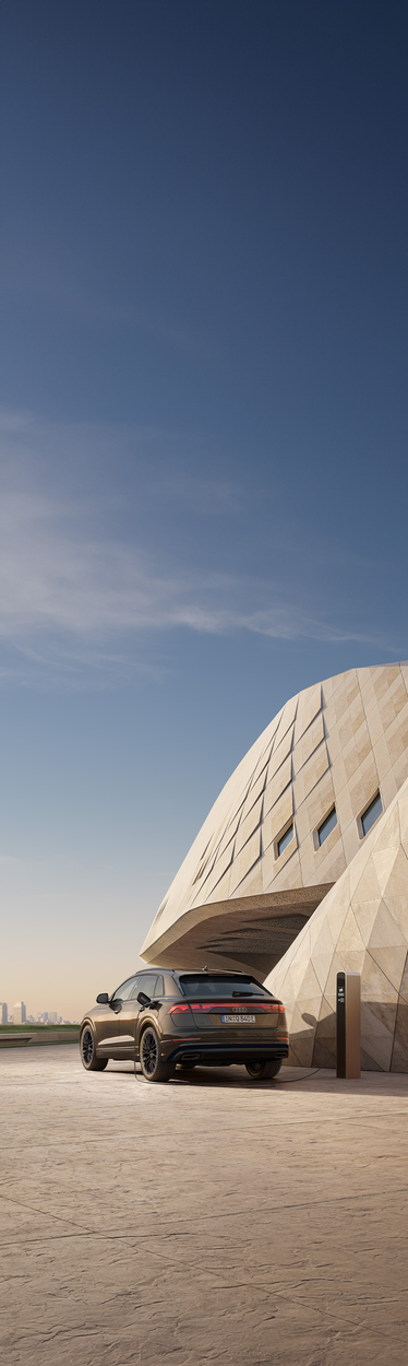 Audi Q8 SUV TFSI e vista trasera en la estación de carga