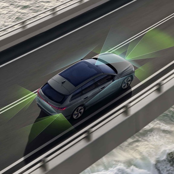 Der A6 Avant e-tron von schräg oben. Vom Heck und der Front aus unterteilen grüne und blaue Vektoren die Flächen hinter und vor dem Fahrzeug.