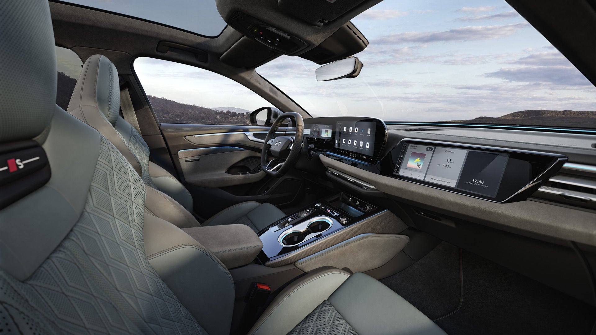 Blick durch das Beifahrerfenster in das Cockpit des A6 Avant. Das Interieur hat mintgraue Bezüge.