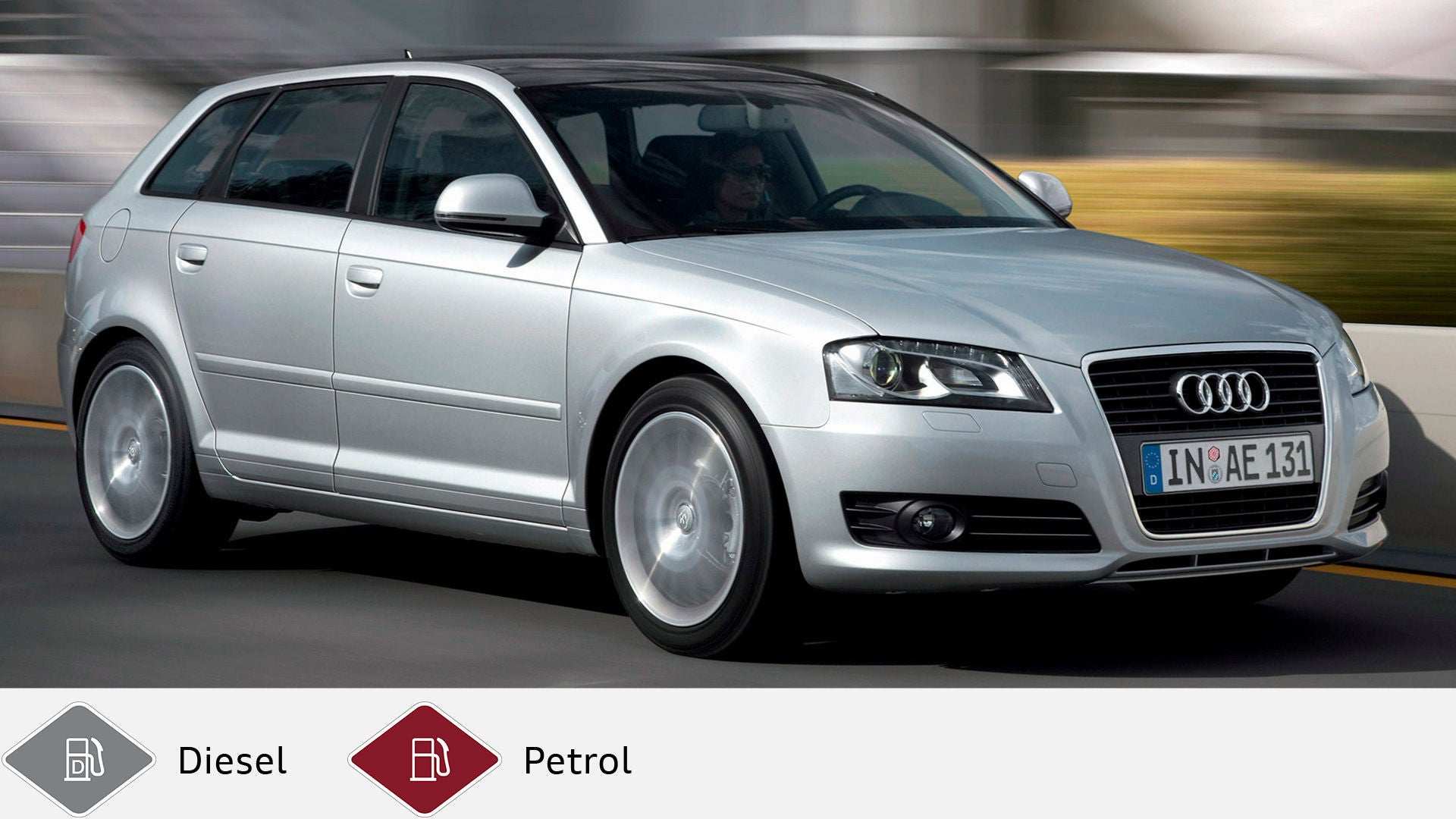 Silver Audi A3 Sportback driving on the road with driver at the wheel, diagonally from the front. Gray diesel symbol and red petrol symbol at the bottom.