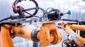 Kuka brand robotic arm with a grinding attachment