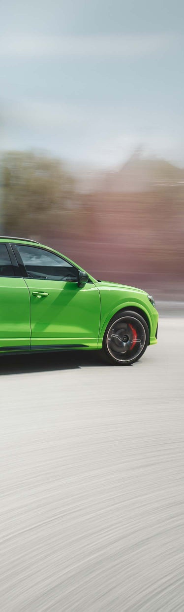 Foto de la parte lateral de un Audi RS Q3 en color verde. 