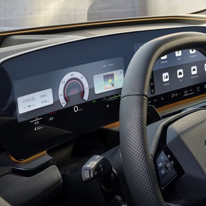 The cockpit and driver display from the perspective of the driver's window. The interaction light in sun yellow can be seen below the windscreen.