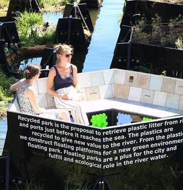 Two women sitting by the water