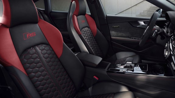 Black and red leather car seats with hexagonal stitching and RS logo.