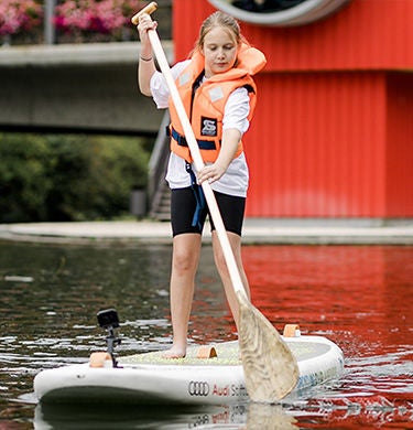 A girl stand-up paddling