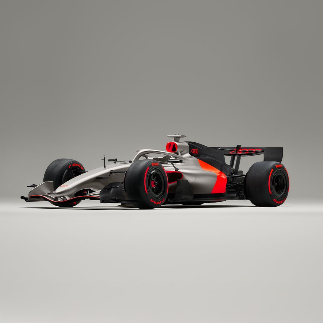 Audi e-tron GT side view on gravel surface in front of a house