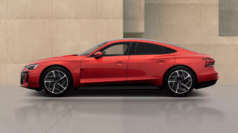 An Audi e-tron GT quattro parked against a modern, minimalist backdrop of beige walls, showcasing its contemporary design and smooth lines.