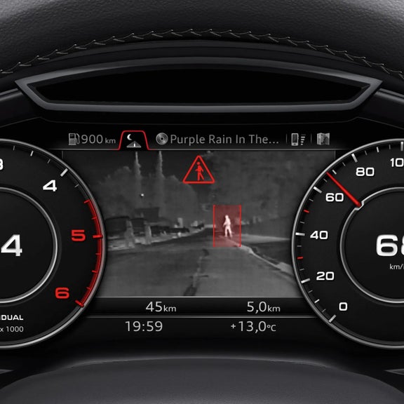 Car dashboard showing speedometer, warning icons, and a pedestrian alert on the head-up display.