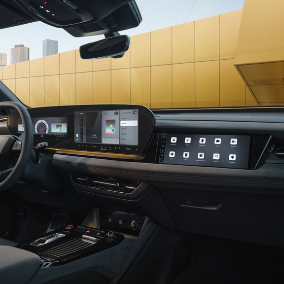 The cockpit and panoramic display as seen from the passenger's perspective. The interior is bathed in sunny yellow ambient lighting.