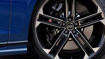 Close up of an Audi car's wheel and rims with Audi logo prominent