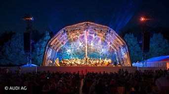 Bunt erleuchtetes Konstrukt über Freiluftbühne