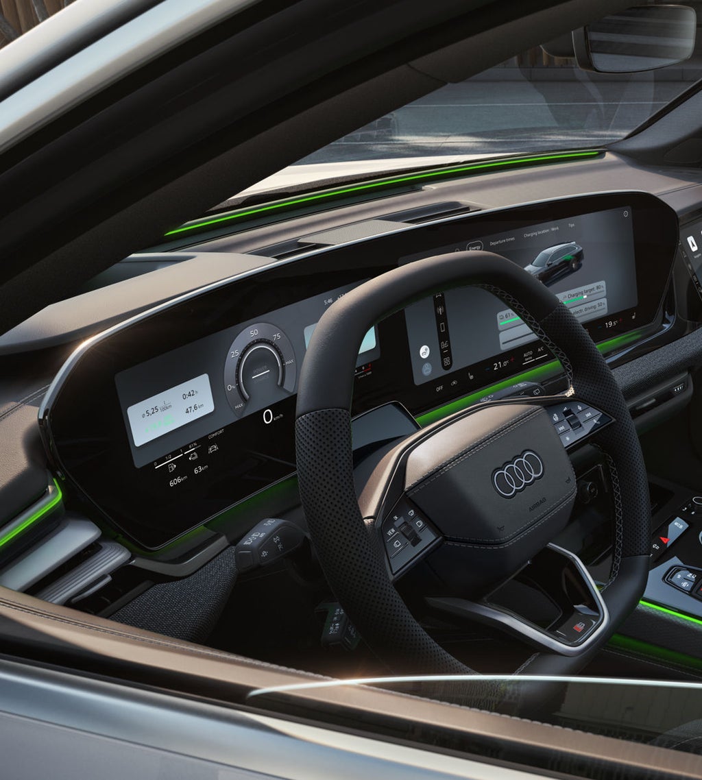 Zicht door het bestuurdersraam op de cockpit van de Audi A6 Avant e-hybrid.