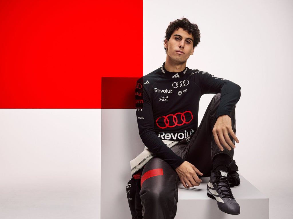 Portrait of Gabriel Bortoleto in racing overalls.