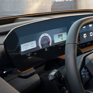 The cockpit and driver display as seen from the driver's window. The interaction light in sunny yellow can be seen below the windshield.