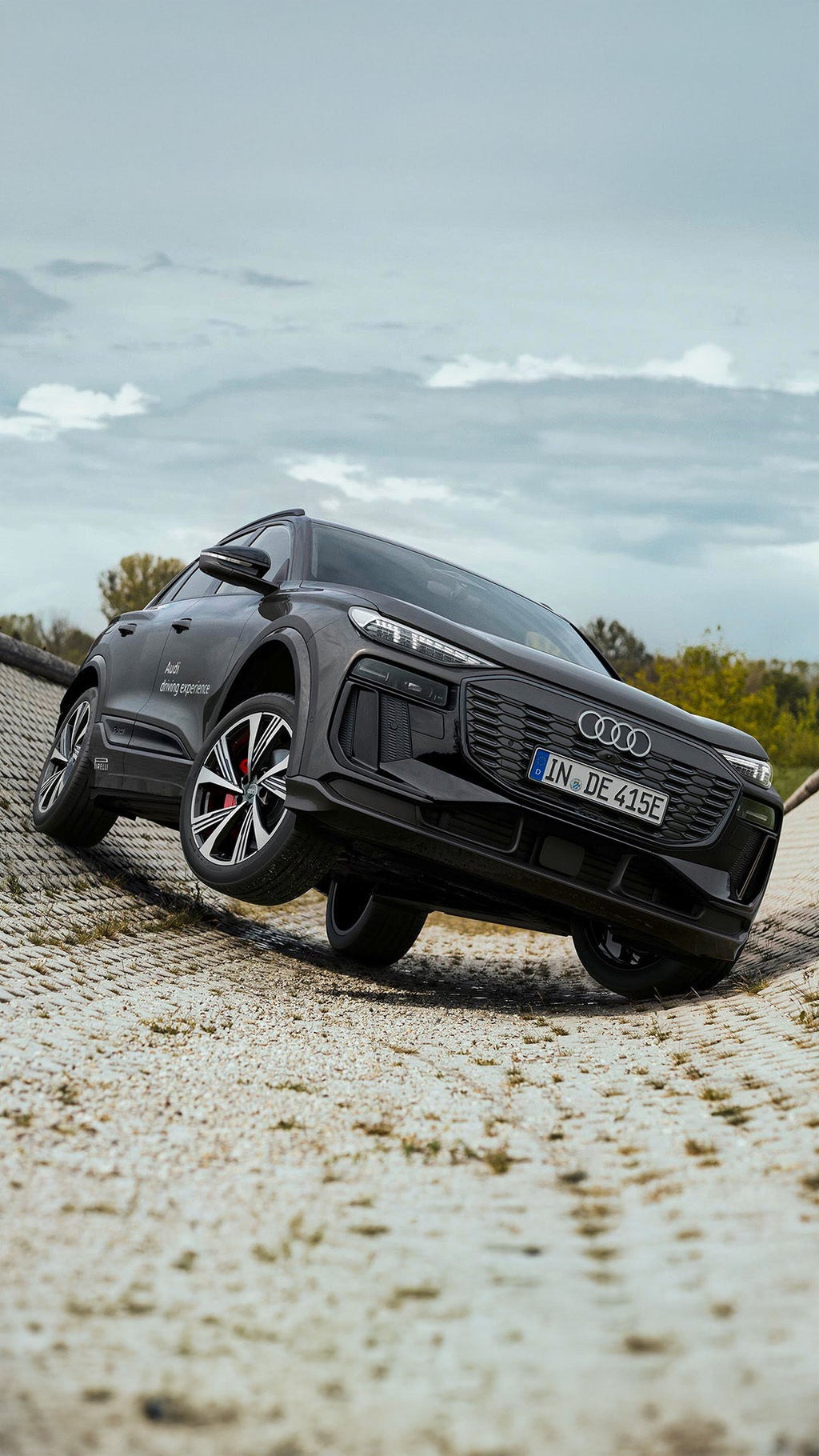 An Audi SQ6 e-tron in front of a steep incline.