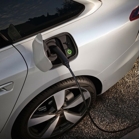 Close up of an Audi charging port while charger is plugged