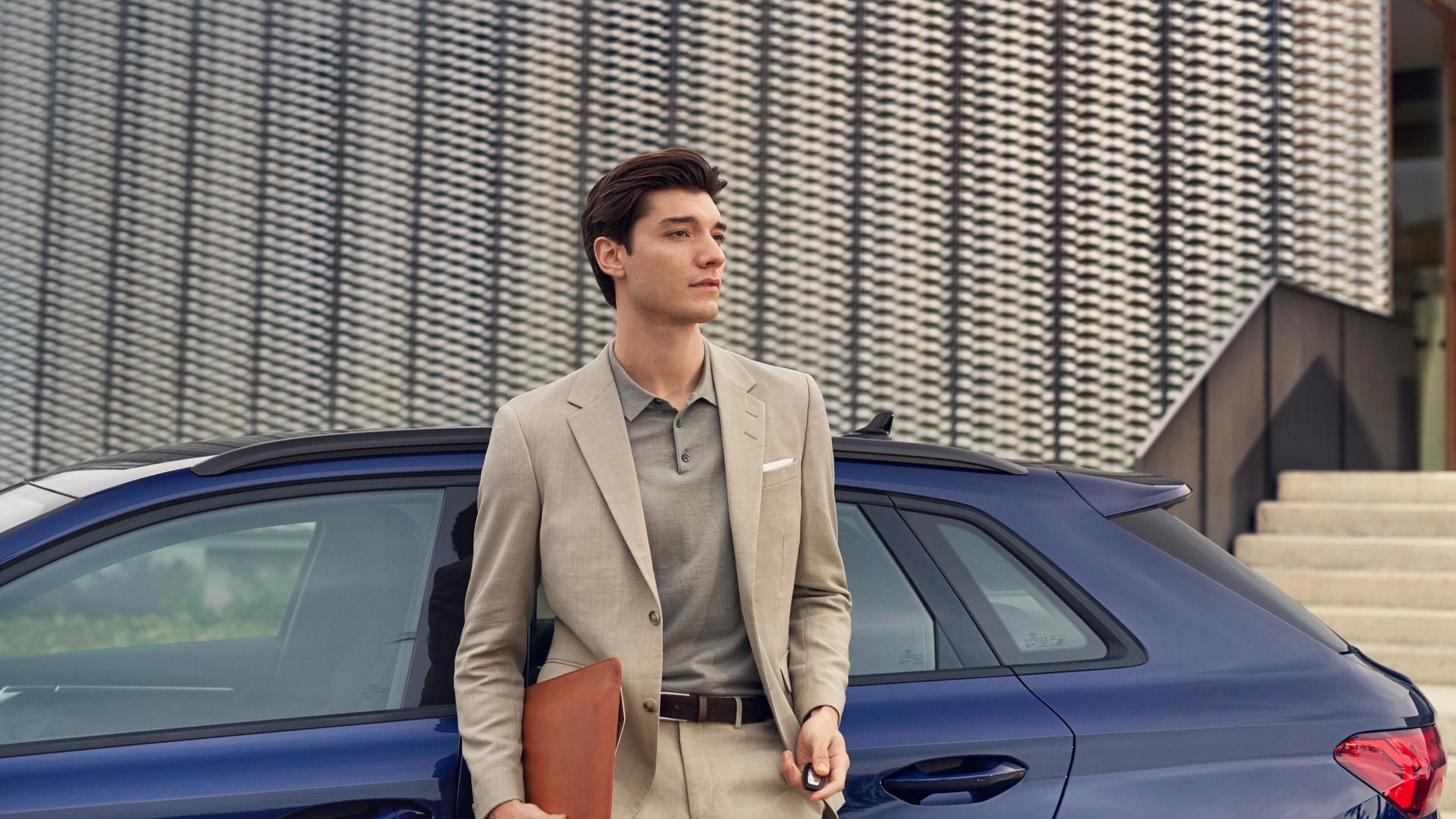 Woman in a light outfit walks confidently near a white electric car charging outside a modern house.