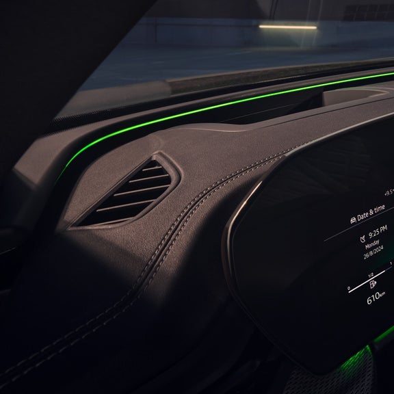 Interior of a car showcasing its digital dashboard and ambient lighting.