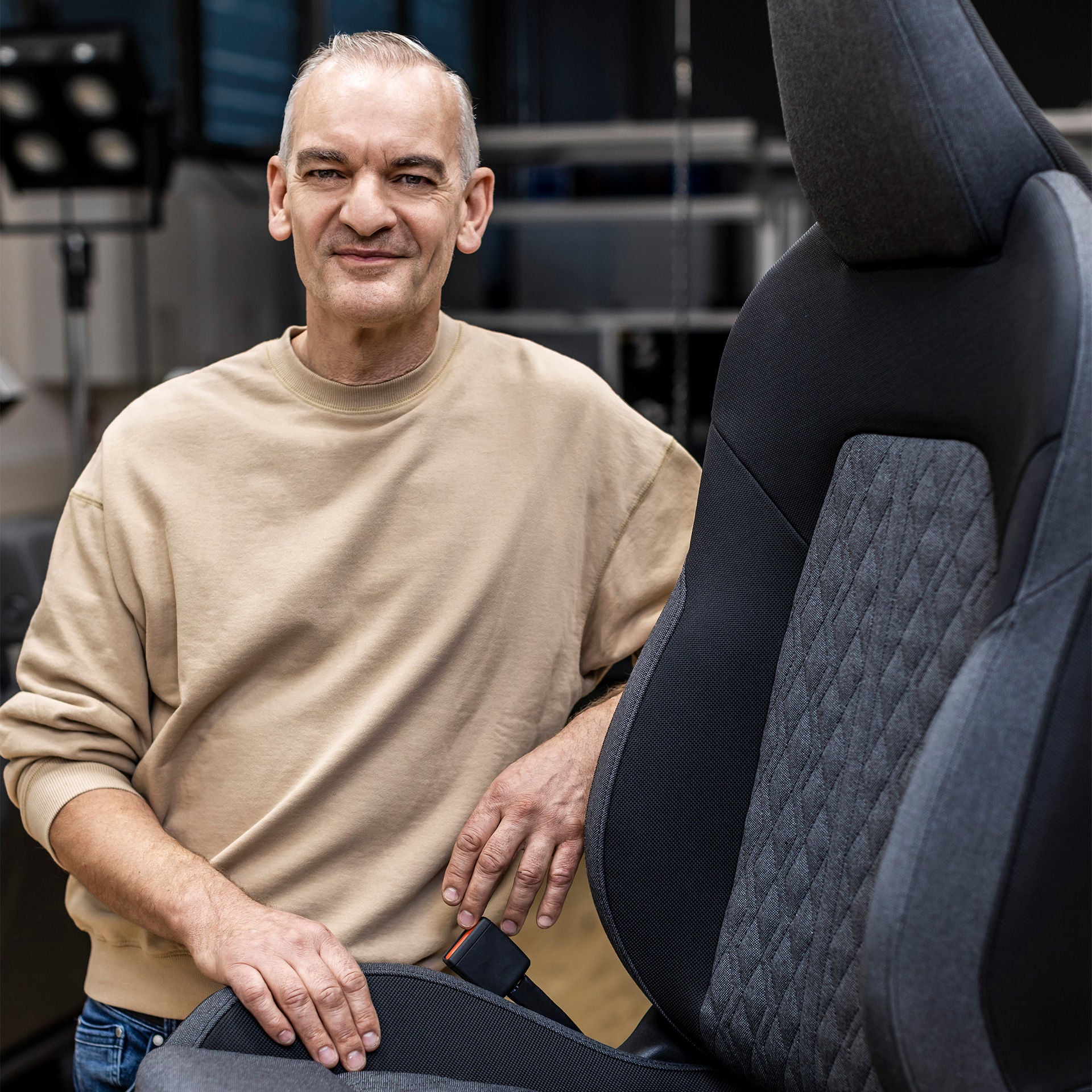 Ernst Günther in portrait next to a car seat