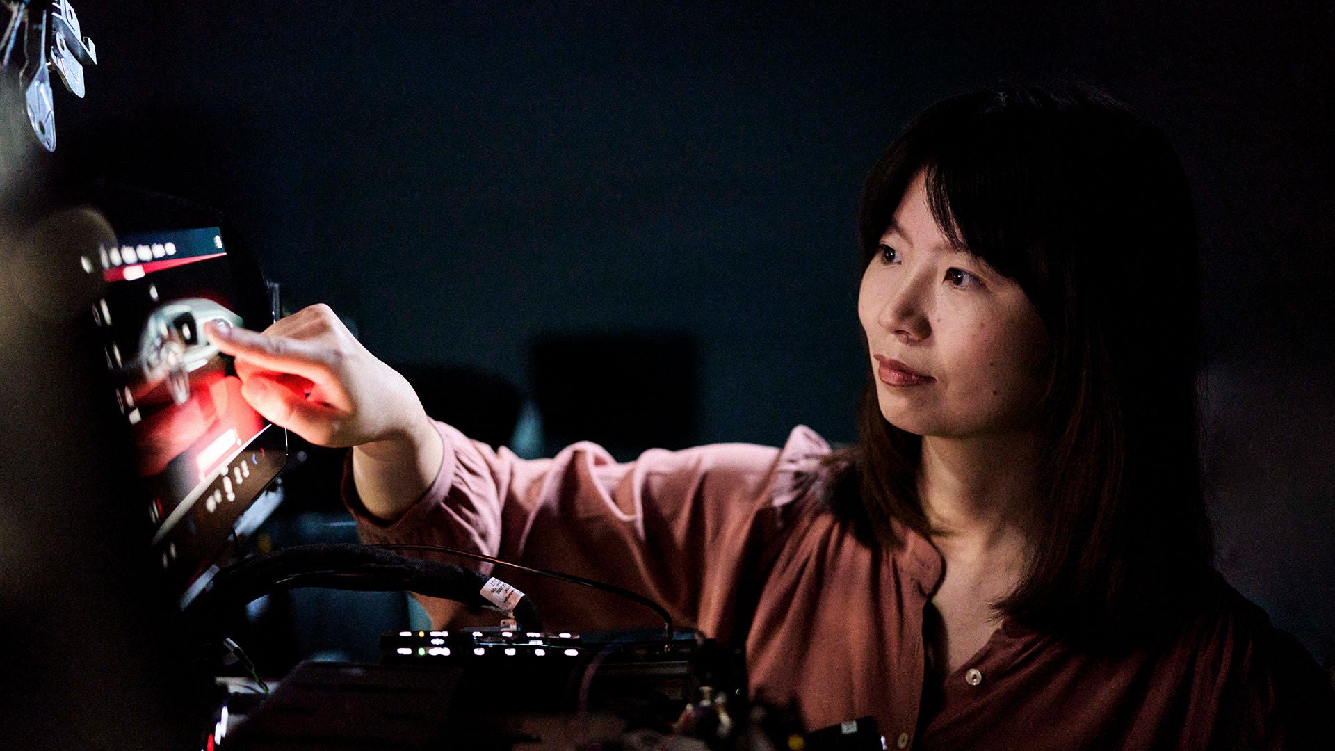 Melanie Schillinger clicks her finger on the screen of a device