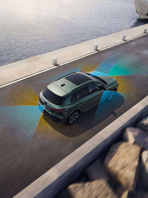 Audi Q3 SUV topshot driving on a street.