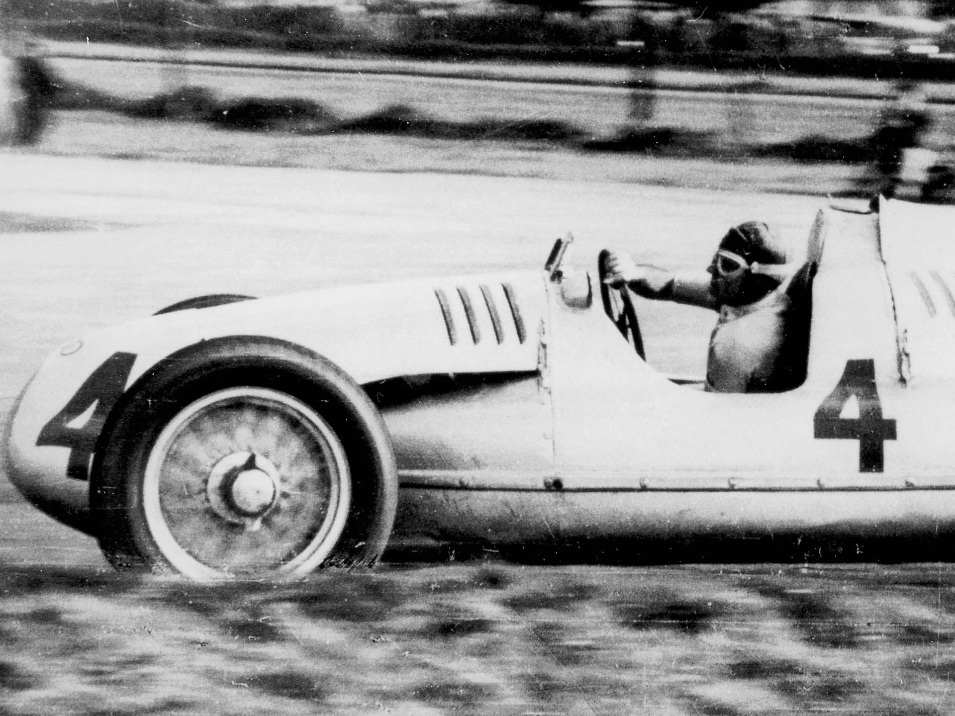 A picture showing an Auto Union Type D Grand Prix race car on track at Donington in 1938.