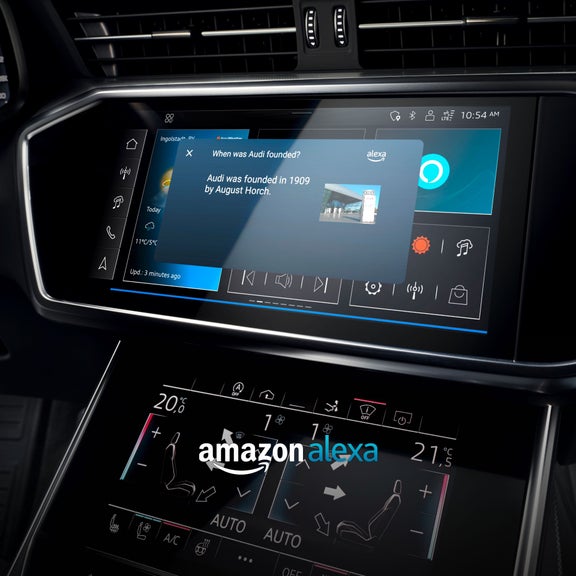 Vehicle infotainment screen displaying Amazon Alexa interface with Audi history information.