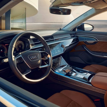 Car interior with leather seats, steering wheel, and modern dashboard.