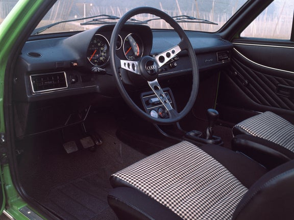 Interior view of the front seats and dashboard of an Audi 80