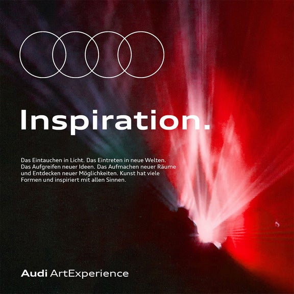 Abstraktes rotes und schwarzes Lichtmotiv mit Audi-Ringen und Text „Inspiration“.