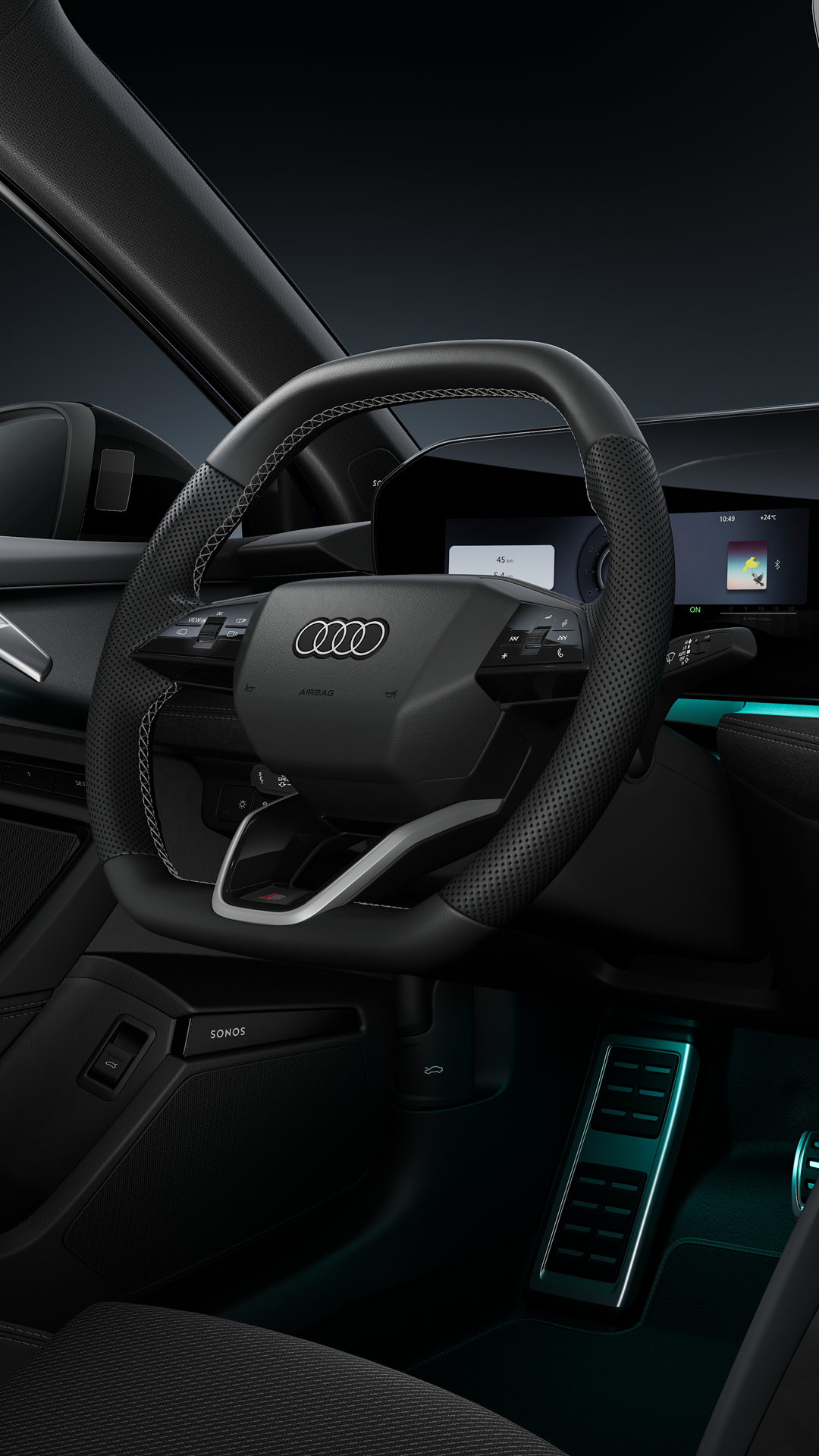 A side view of the cockpit, featuring the sports steering wheel, the curved panoramic display and the ambient lighting.