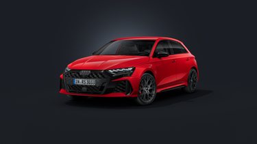 The Audi RS 3 Sportback, viewed from the front at an angle against a dark background.