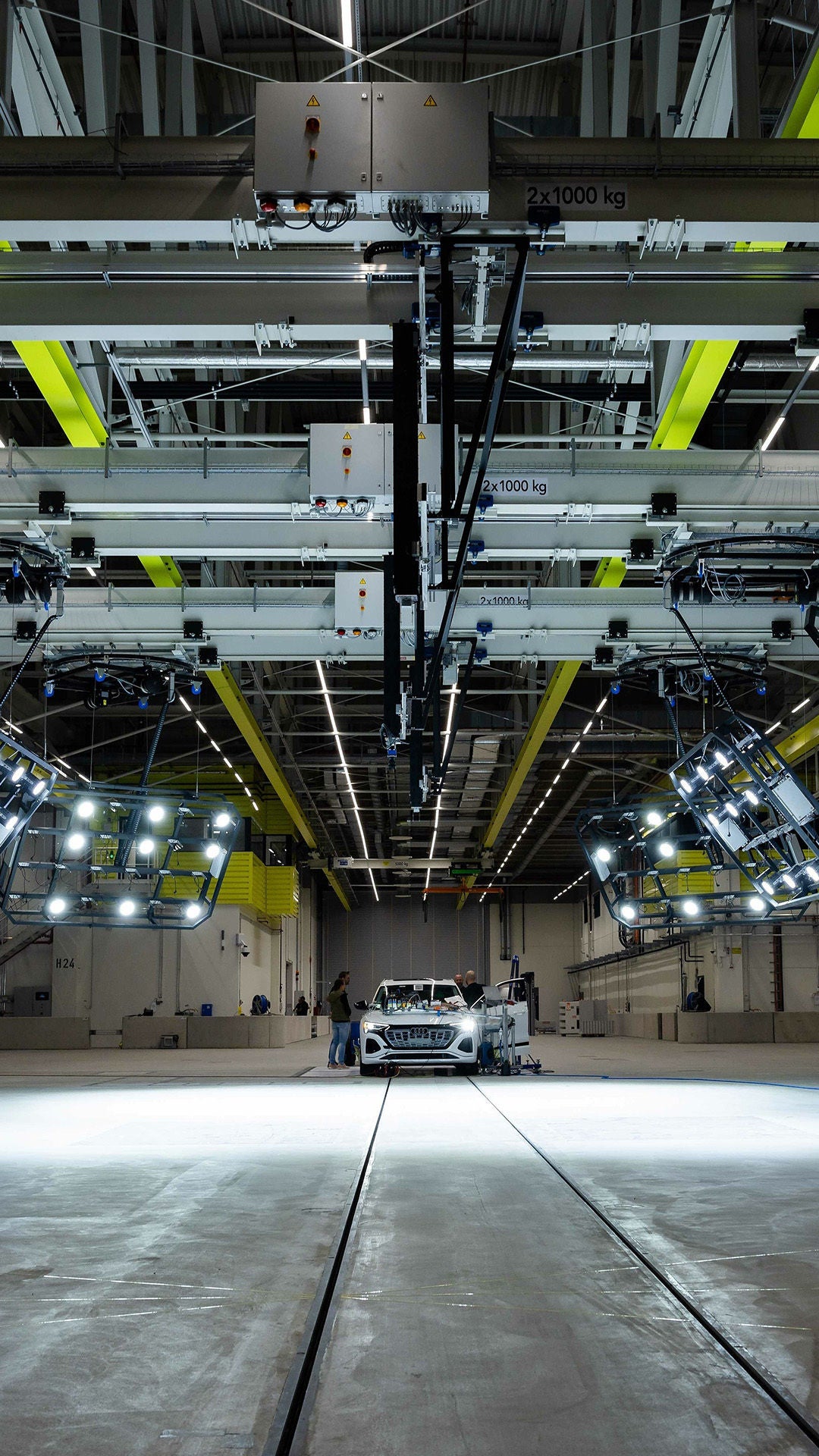 White Audi in a large test hall under special lighting