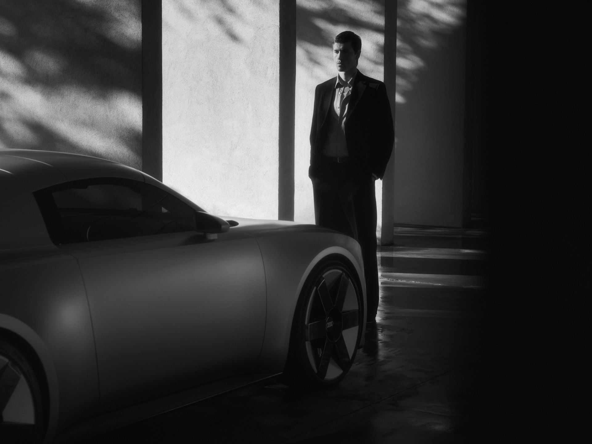 Harris Dickinson stands in front of the Audi Concept C.