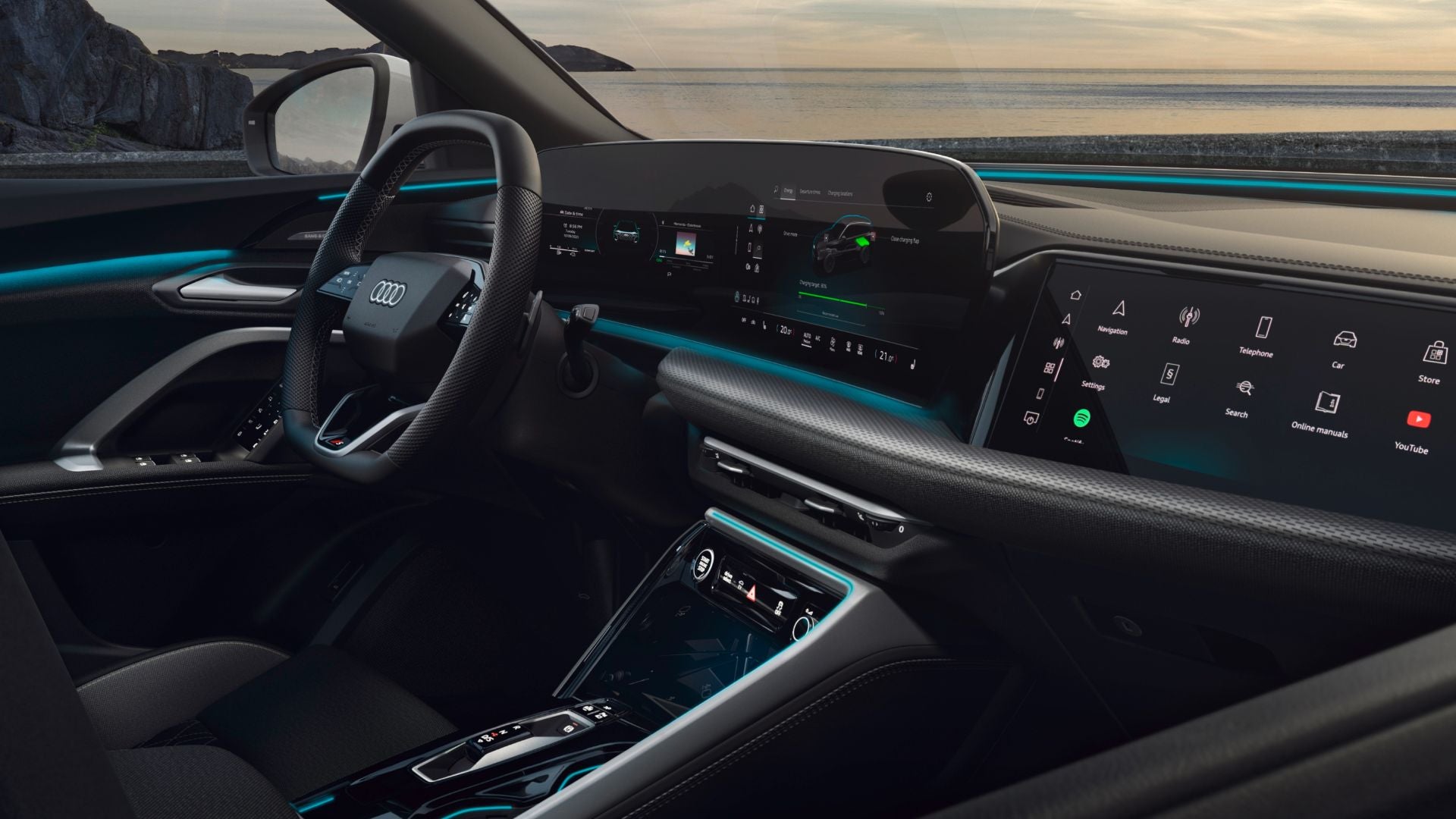 Close-up view of an Audi car's modern interior, featuring a sleek dashboard, digital displays, and ambient lighting along the edges.