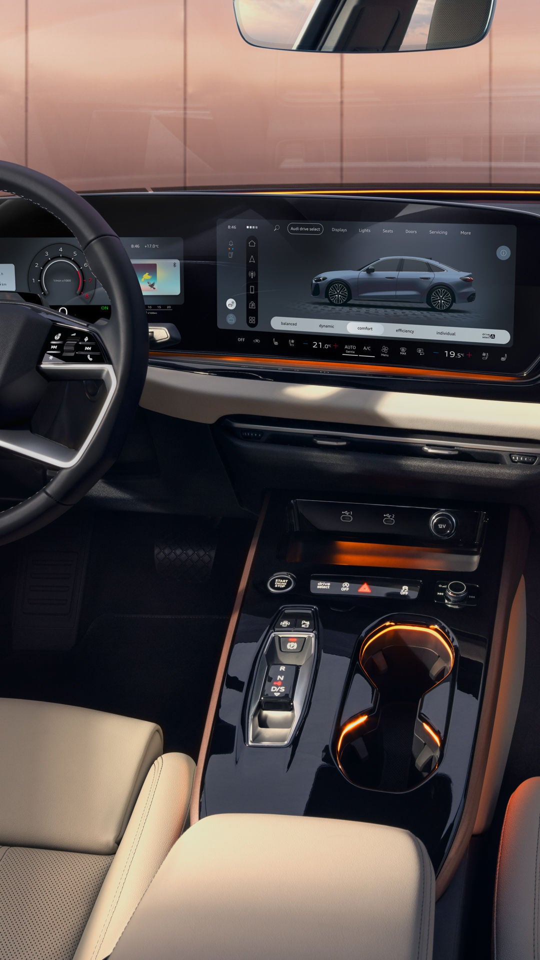A view from the rear seat into the cockpit of the A5 Saloon. Visible features include the MMI displays and the lighting design, featuring the interaction light at the base of the windshield.