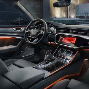 Interior of an Audi car with orange light theme