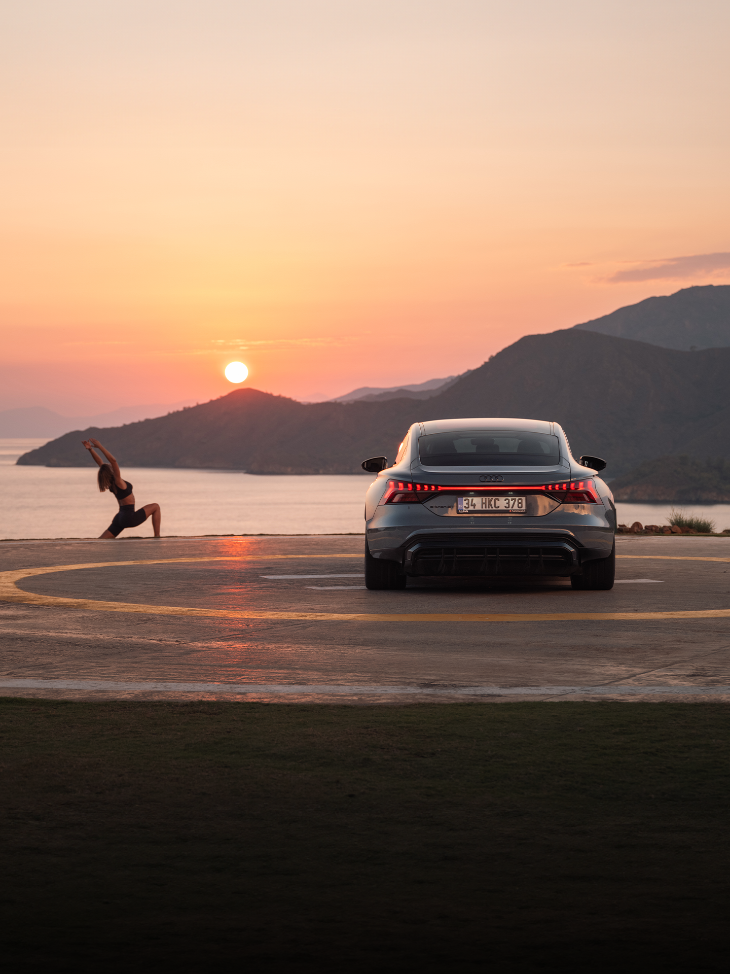 Audi RS e-tron GT sports car on a concrete surface in front of futuristic architecture
