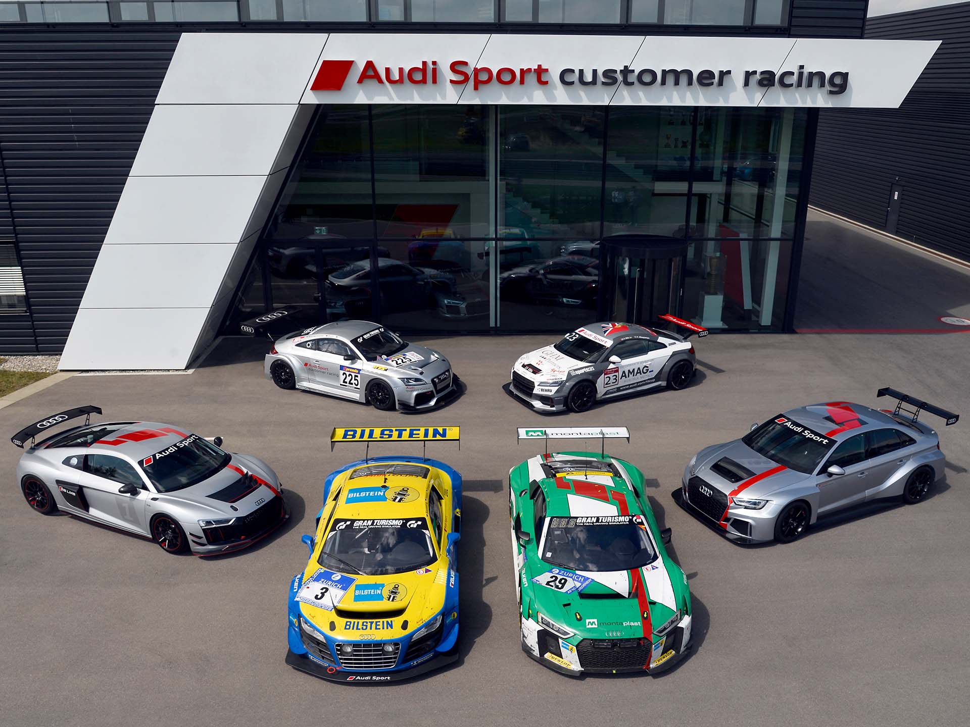 A picture showing a collection of six race cars from the history of Audi Sport customer racing.