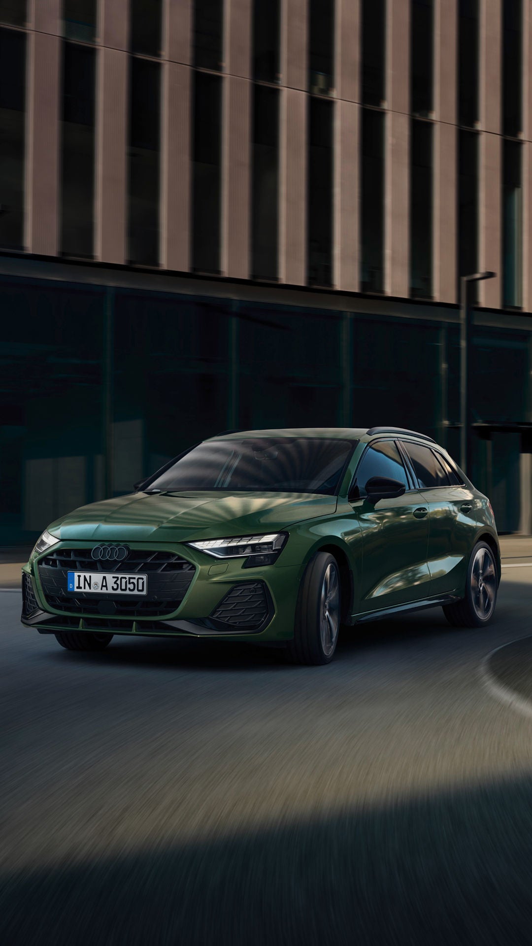 green Audi swerving on a bend