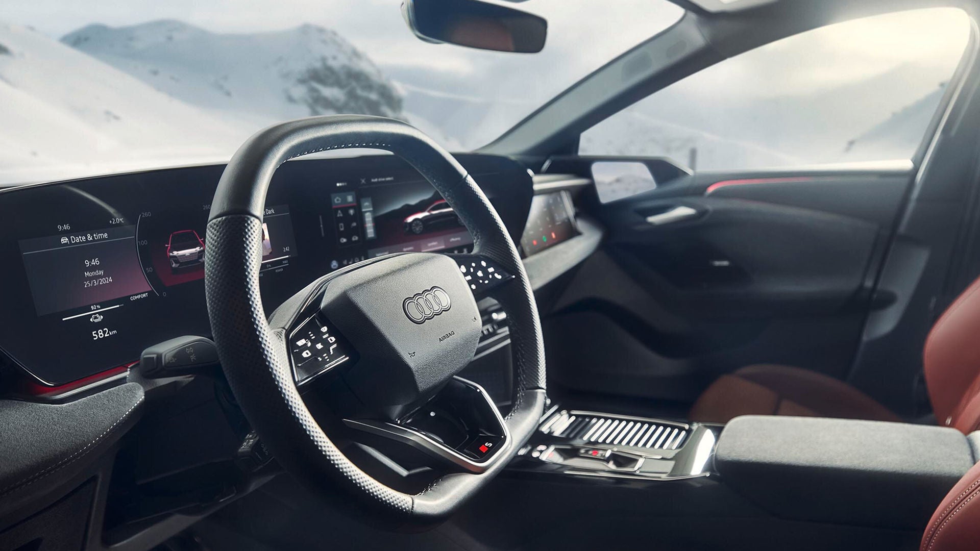 Audi S6 Sportback e-tron drives along a scenic coastal road, showcasing its sleek design against a backdrop of ocean and rocky cliffs.