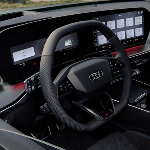 View of the cockpit with focus on the steering wheel with gear selector.