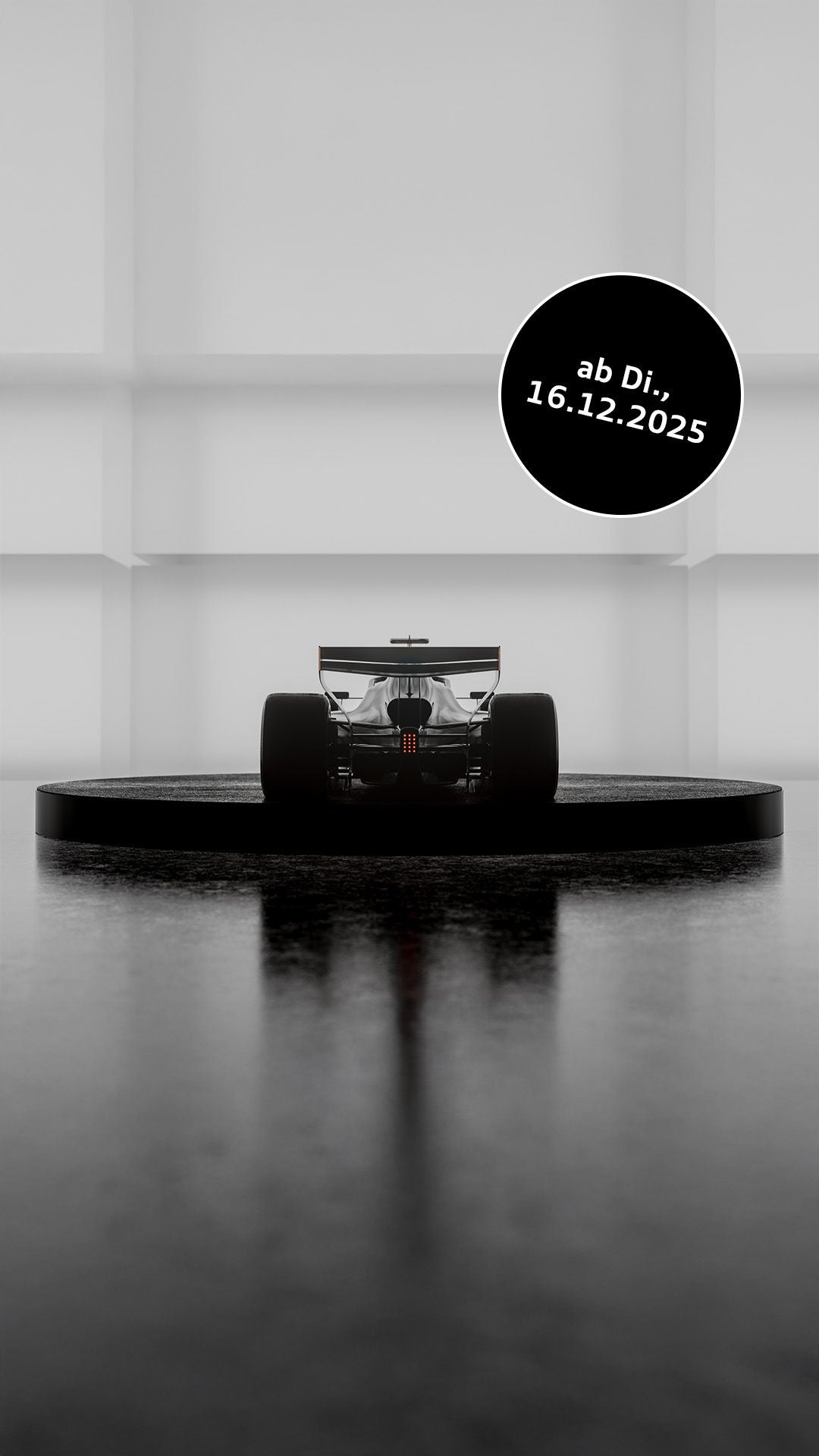 A Formula 1-style racing car, minimalistically backlit, stands on a round platform in a bright, futuristic-looking room.