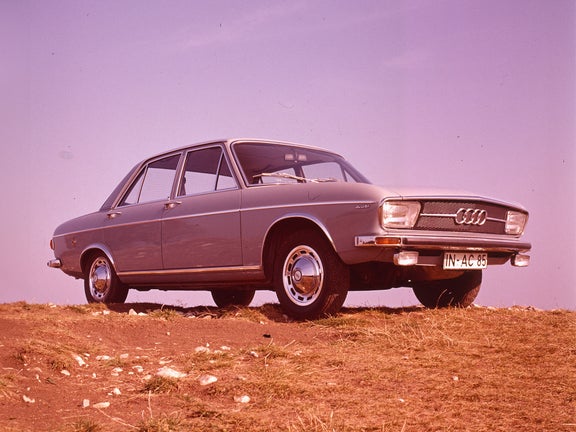 Audi 100 LS in gray from the front side view on a grassy area