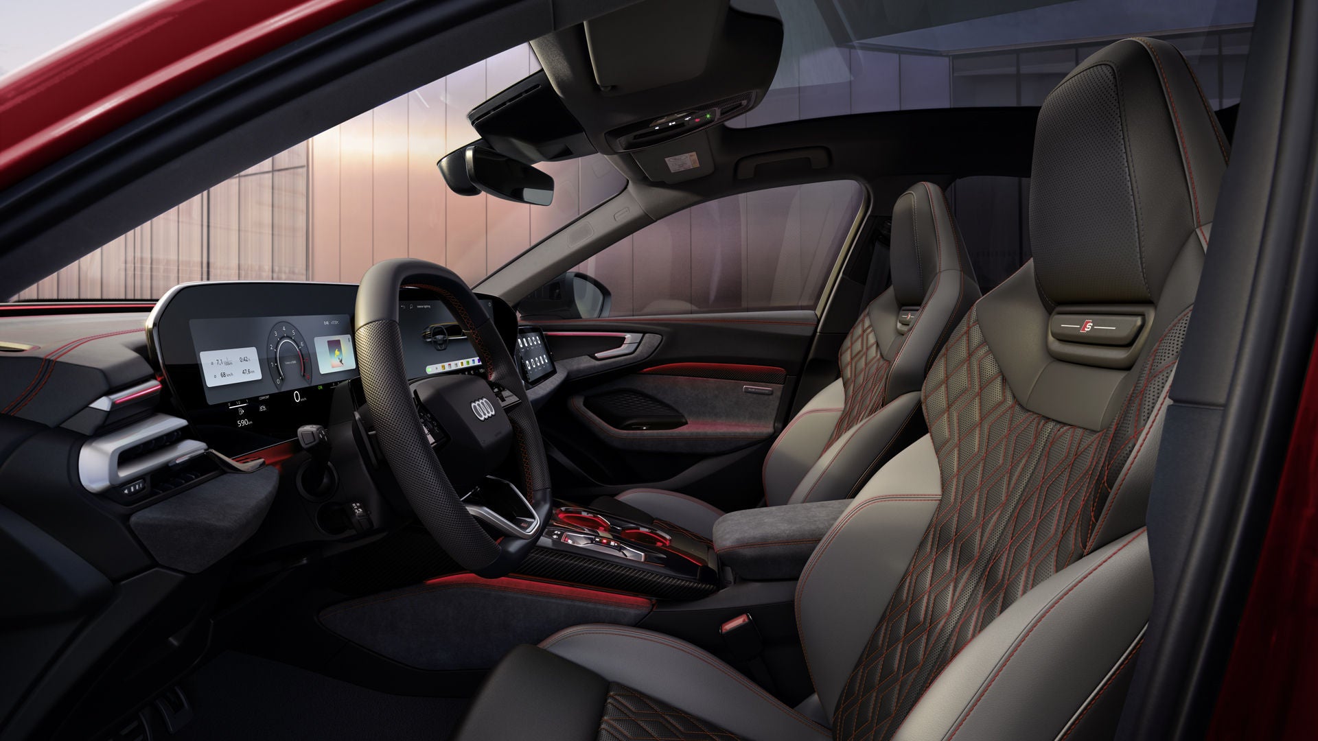 A view through the driver's door into the cockpit of the A5 Saloon. The interior upholstery is black and Jet Grey with crimson red accents.
