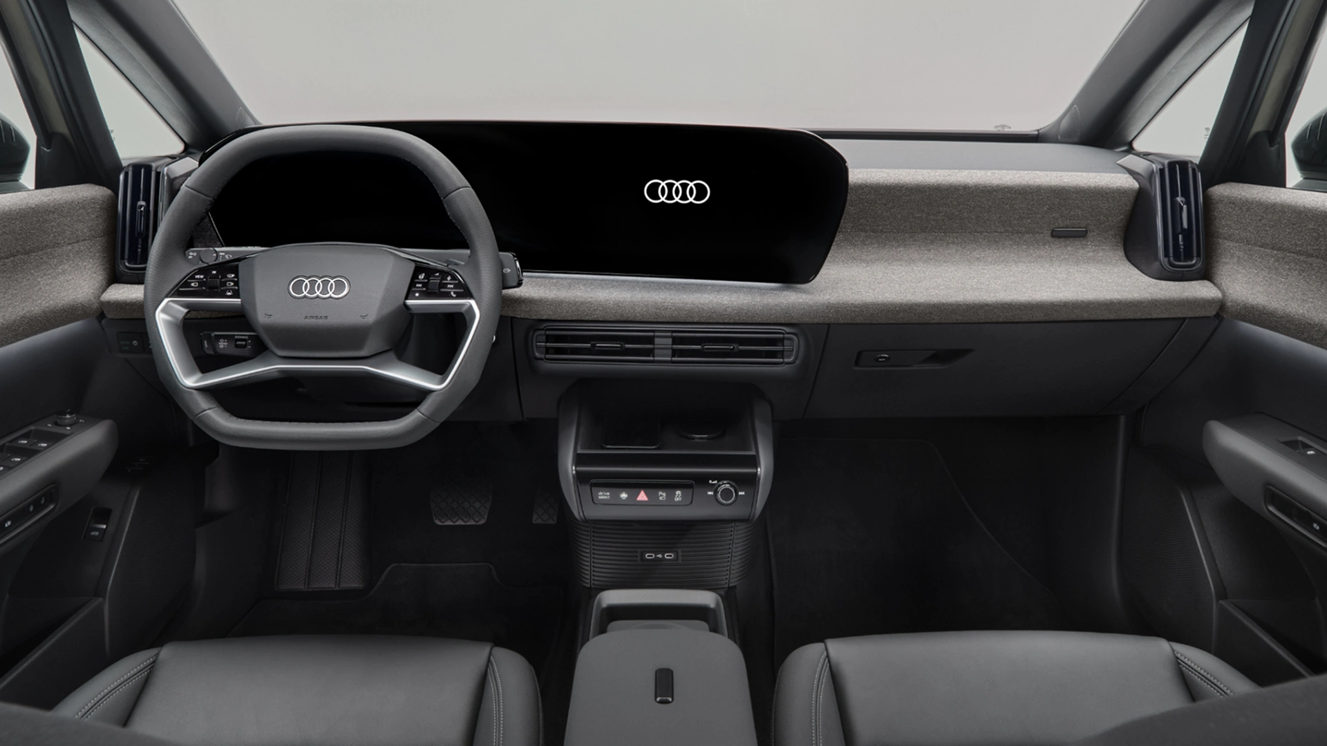 Interior view of the Audi A2 e-tron electric car dashboard showing digital displays and steering wheel