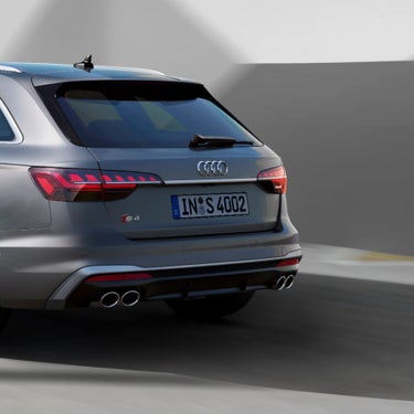 Silver Audi S4 Avant accelerating on a road with motion blur effect.